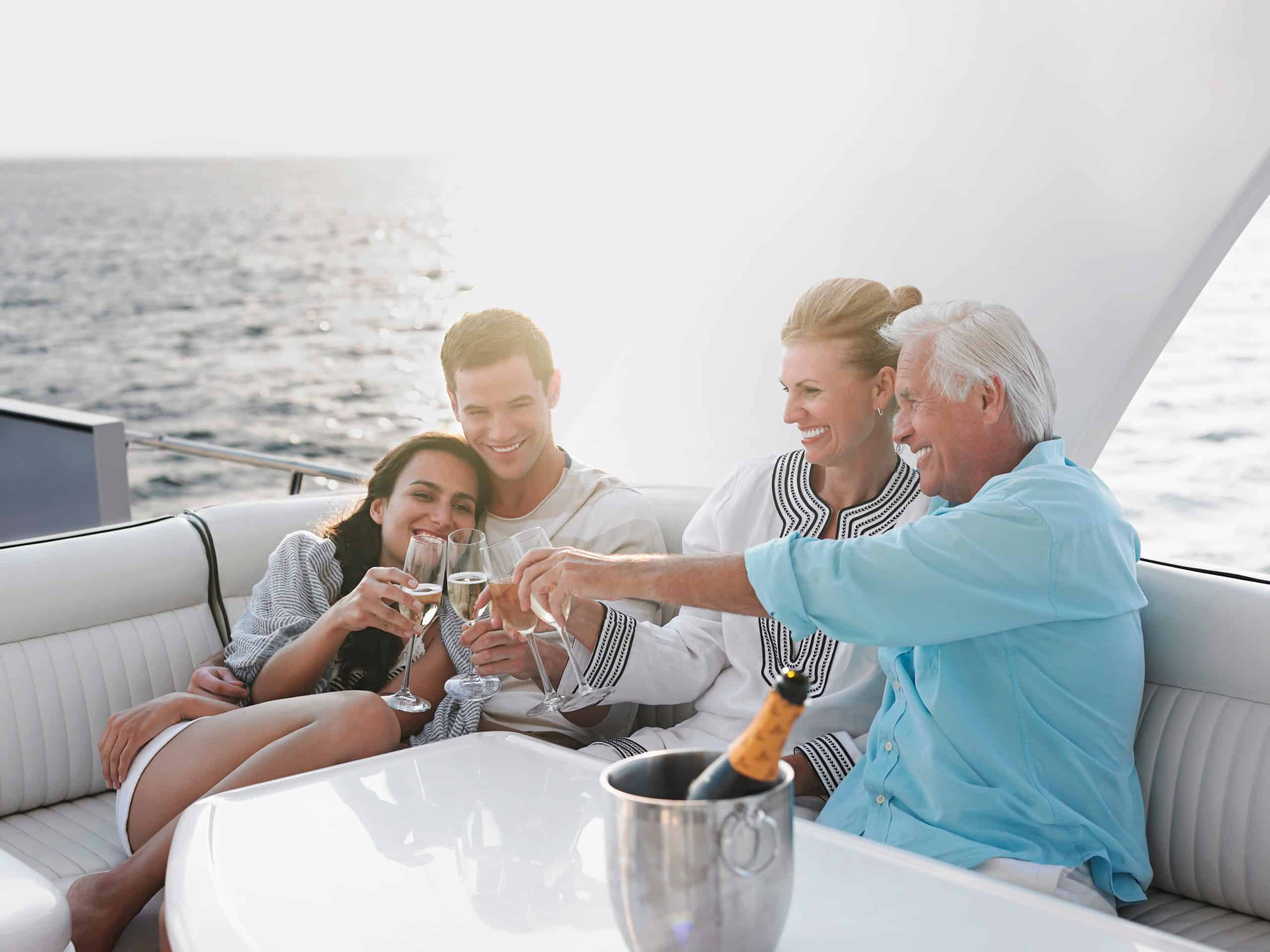 Two,Generational,Family,Celebrating,With,Champagne,On,Yacht